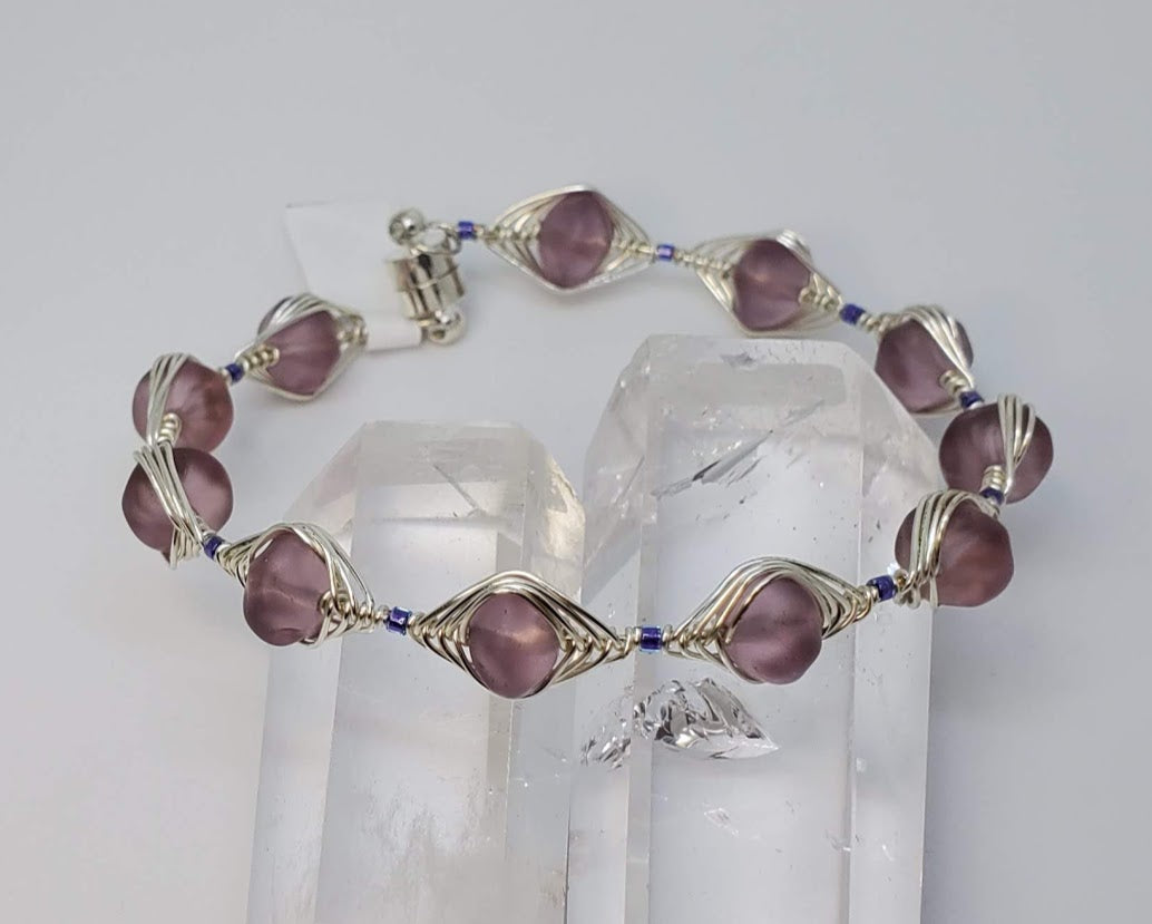 Purple Rondell Sea Glass wrapped in silver Artistic Wire 20 gauge with magnetic clasp.
