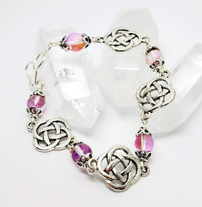 8 " Celtic Themed Bracelet with handmade hook/eye clasp. The Pink illuminate bead flickers in the light. Made with nickel free silver tone metal.